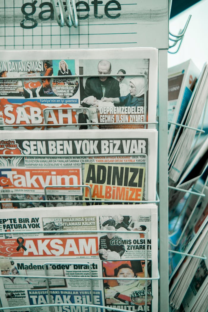 Close-up of Turkish newspapers in a stand with headlines visible.